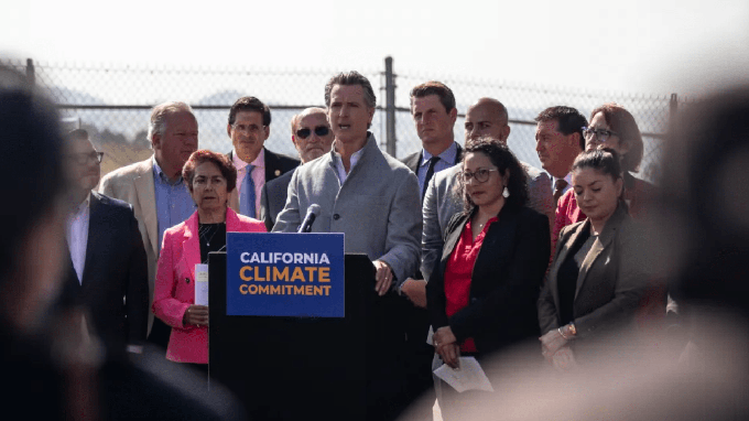 Image caption: California Gov. Gavin Newsom signs a number of climate-related bills surrounded by state legislators at a press conference at the USDA Forest Service Regional Office on Mare Island in Vallejo on Sept. 16, 2022.