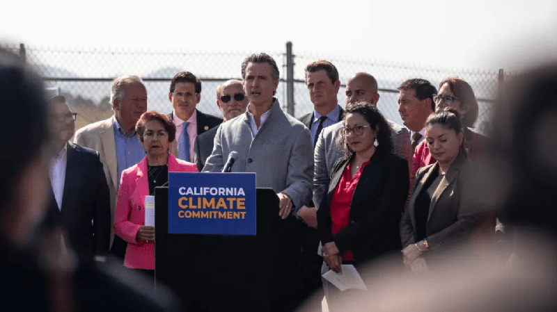 California Gov. Gavin Newsom signs a number of climate-related bills surrounded by state legislators at a press conference at the USDA Forest Service Regional Office on Mare Island in Vallejo on Sept. 16, 2022.