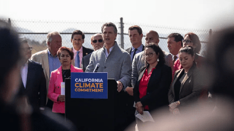 Image caption: California Gov. Gavin Newsom signs a number of climate-related bills surrounded by state legislators at a press conference at the USDA Forest Service Regional Office on Mare Island in Vallejo on Sept. 16, 2022.