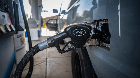 Image caption: A gas nozzle in a van at a central Fresno gas station on Sept. 29, 2022.