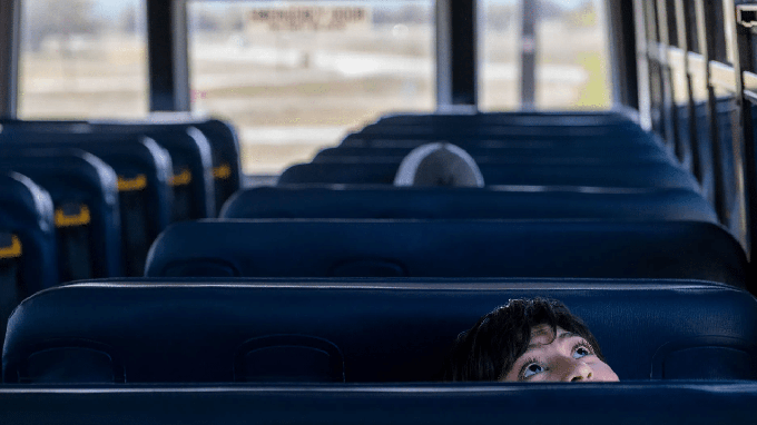 Image caption: Almarissa Segura, 14, a student at San Antonio Elementary School in Lockwood, looks up while seated on a school bus. She was part of a CatchLight and CalMatters photo project that captured student life during the pandemic in California.