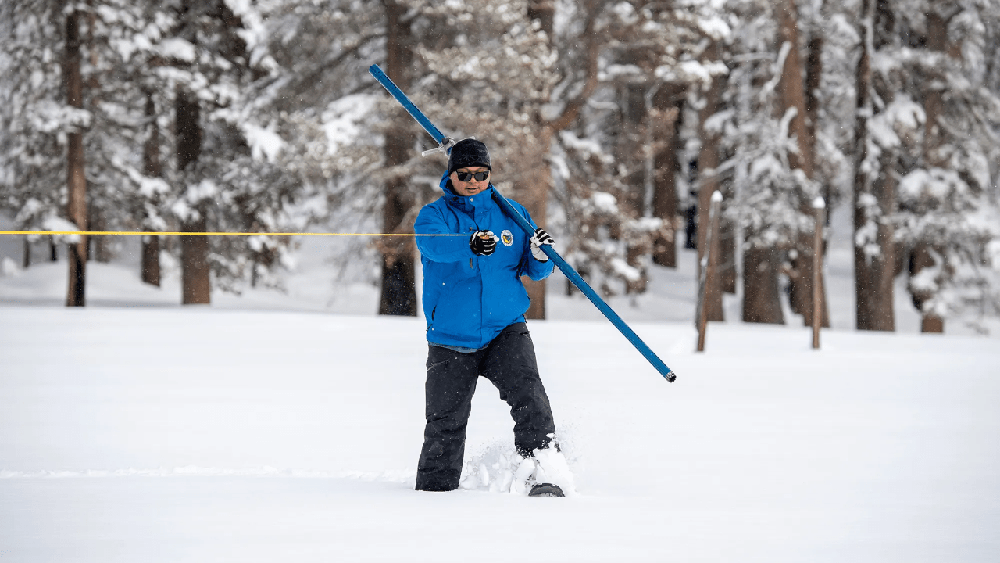 Sean de Guzman of the California Department of Water Resources conducts the first snow survey of the 2023 season at Phillips Station in the Sierra Nevada Mountains on Jan. 3.