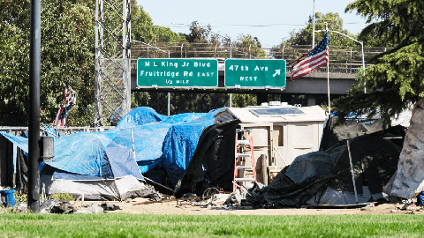 Image caption: A homeless camp along Interstate 80 in Sacramento.