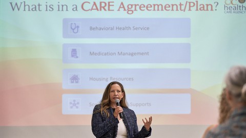 Image caption: Orange County Health Care Agency psychologist Stacey Berardino speaks about CARE Court at St. Irenaeus Catholic Church in Cypress.