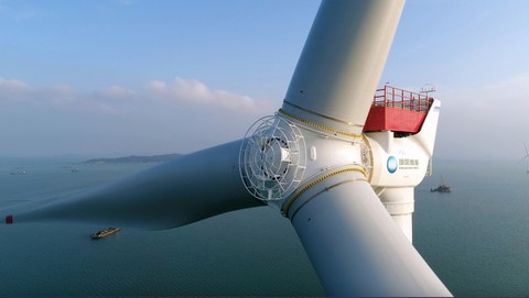 Image caption: There is a wind-turbine arms race underway in China, which already manufactures windmills whose blades sweep an area the size of 10 football fields per spin.