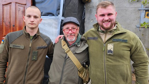Image caption: JP Reese, a registered nurse, stands with a couple of Ukranian soldiers near the front lines of the war zone. The photo was taken by JP's bride, Dawn Davidson, two weeks after they were married in Sacramento.