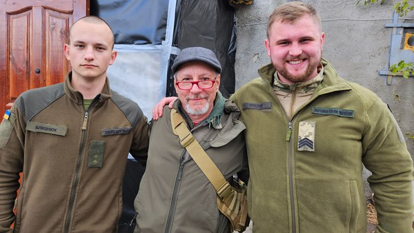 JP Reese, a registered nurse, stands with a couple of Ukranian soldiers near the front lines of the war zone. The photo was taken by JP's bride, Dawn Davidson, two weeks after they were married in Sacramento.