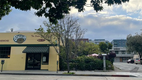 Image caption: New six-story apartment buildings in downtown Santa Cruz loom large over a funky one and two-story plaza one block away which is home to Redwood Records, The Bagelry (est 1977) and the world renowned Kuumbwa Jazz Center.