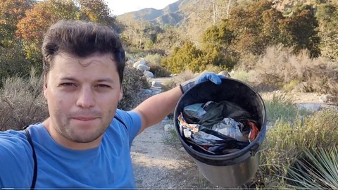 Image caption: Edgar McGregor picking up trash on March 18, 2024 in Eaton Canyon. Ten months later, McGregor’s posts on Facebook saved a lot of lives as the Eaton Fire blazed through Altadena.