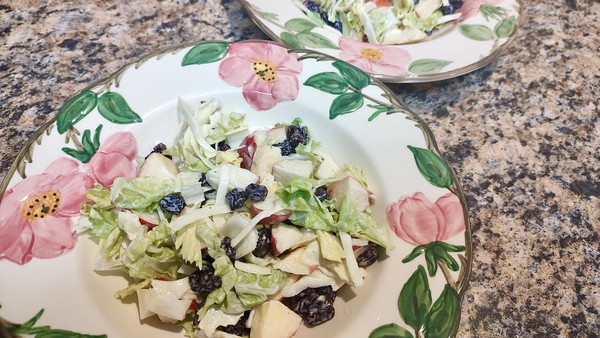 Here's a fresh and crunchy take on Waldorf salad, with lettuce and cabbage adding heft, and almonds standing in for walnuts.