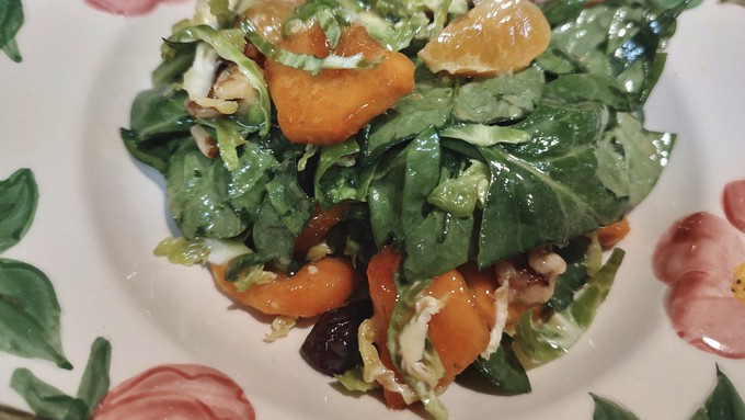 Persimmon and mandarin slices bring pop to this salad. Dried cherries and pecans add texture.