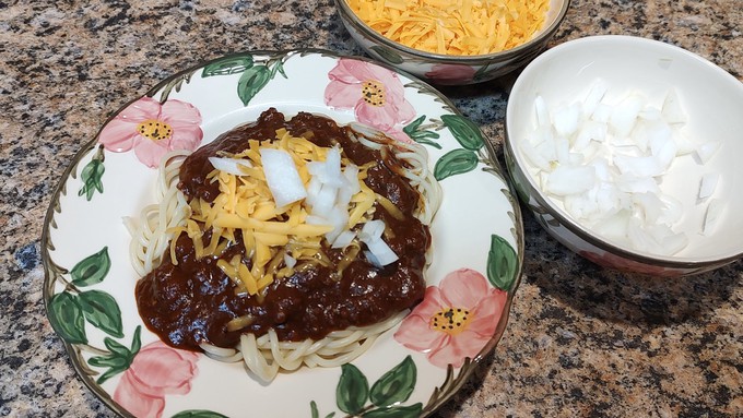 Chopped onions and shredded cheese are traditional toppings for Cincinnati chili.
