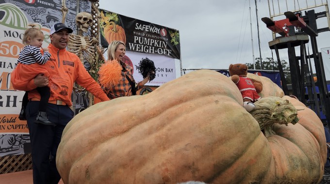 This pumpkin set a new world record, weighing 2,749 pounds, from Minnesota. Winner Travis Gienger and his family pose with the massive gourd at Monday's Safeway World Championship Pumpkin Weigh-Off.