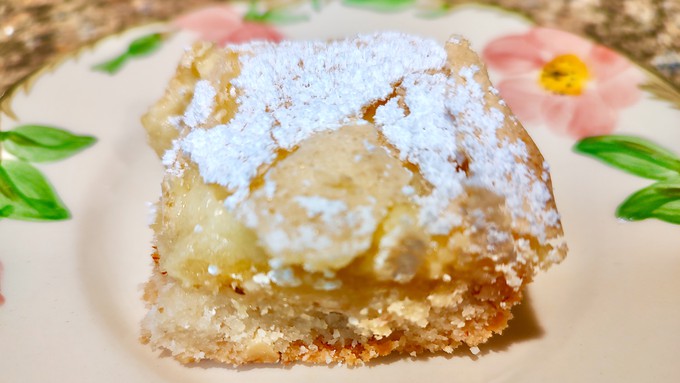 A sprinkle of powdered sugar is the final touch for Meyer lemon bars with almond crust.