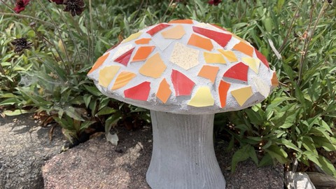 Image caption: This cute little mushroom features a mosaic cap. Learn to make this garden decor in a Secret Garden class on July 14.