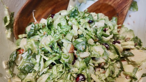 Image caption: Shredded Brussels sprouts are the starting point for this green and red coleslaw, perfect for a holiday meal.