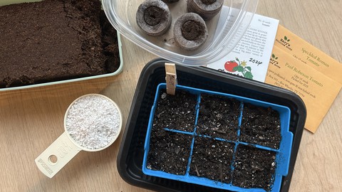 Image caption: Here are some items that are useful for seed-starting: Clockwise from top left, a tray of rehydrated coconut coir, a food storage container with 4 expanded pellets, seed packages, a silicone 6-pack with seed starting mix, and a measuring cup with perlite.