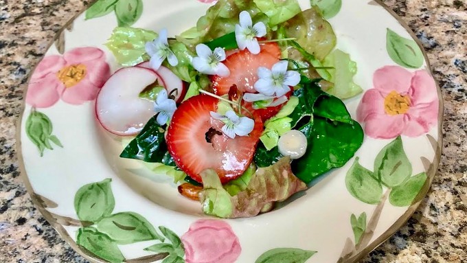 Nothing says spring like this pretty strawberry salad adorned with edible violets. (Photo: Debbie Arrington)