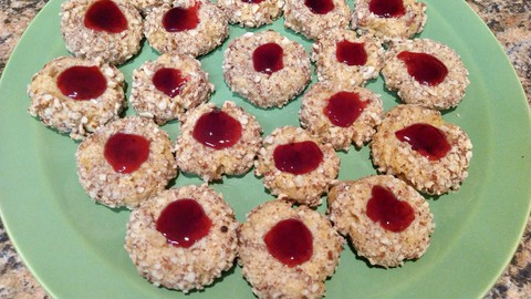 Image caption: How festive are these! Classic thumbprints get a California twist with almonds and pomegranate jelly.