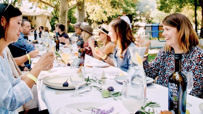 Celebrants toast the meal, the chefs and the fundraising cause at a previous Village Feast in Davis' Central Park. This year's event is Sept. 22.