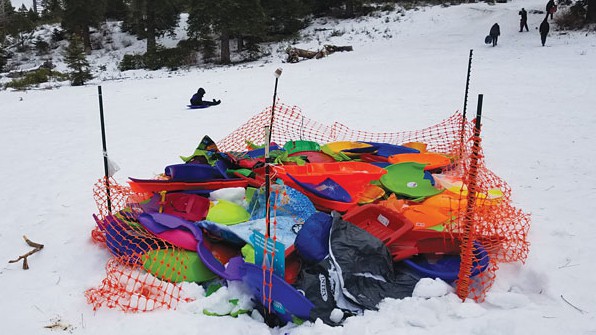 A sled corral full of broken plastic sleds at Fallen Leaf Lake Hill.
