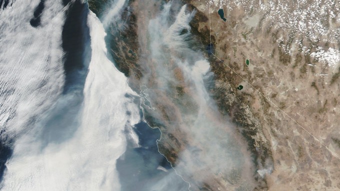 Image caption: A NASA satellite image of the Caldor Fire burning east of Sacramento.