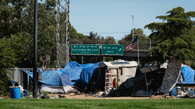 Image caption: Measure O would would allow law enforcement officers to clear homeless encampments, like this one in south Sacramento, even if there are no shelter beds available.