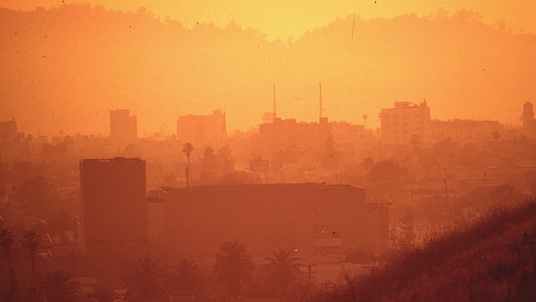 Air pollution, such as seen here in Los Angeles circa 1972, contains greenhouse gases which cause the climate to change.