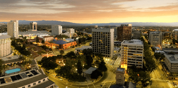 Looking down at the Plaza de Cesar Chavez in Downtown San Jose, “The Capital of Silicon Valley.” The reddish building at center-left is the Tech Museum of Innovation.