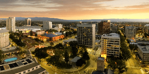 Image caption: Looking down at the Plaza de Cesar Chavez in Downtown San Jose, “The Capital of Silicon Valley.” The reddish building at center-left is the Tech Museum of Innovation.