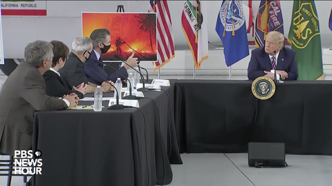 Image caption: President Donald Trump sits across from California Governor Gavin Newsom at a press conference on the state’s increasingly destructive fire season. Screen shot from the PBS NewsHour YouTube channel.