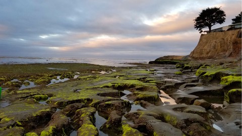 Image caption: King tides and cloud-filled sunsets are signs that winter has come to Santa Cruz.