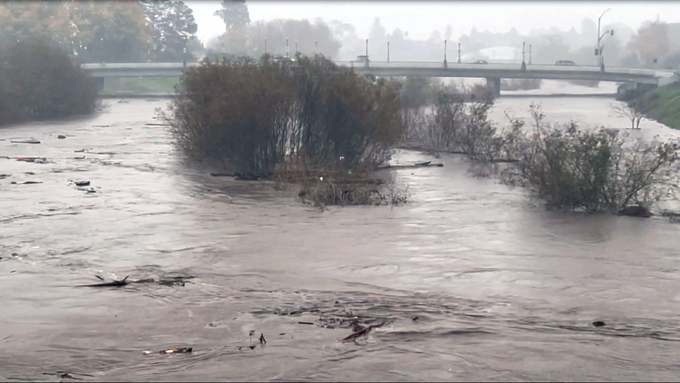 Image caption: A view of the San Lorenzo River from the Soquel Avenue Bridge—which fared better in this storm than in 1982, when it collapsed.