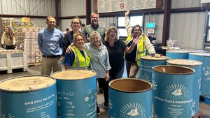 Second Harvest CEO Erica Padilla-Chavez (at right) with a group of local Rotary members who helped wrap Holiday Food & Fund Drive barrels.