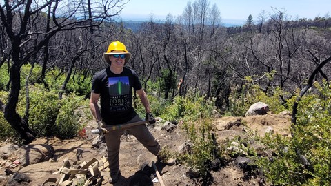 Image caption: Mike Kahn, Hilltromper's managing director, doing volunteer trail work with Santa Cruz Mountains Trail Stewardship at San Vicente Redwoods.
