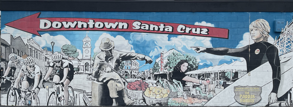 The Downtown Santa Cruz is That Way mural, on the side of the Beach Street Boutique across from the Santa Cruz Wharf.