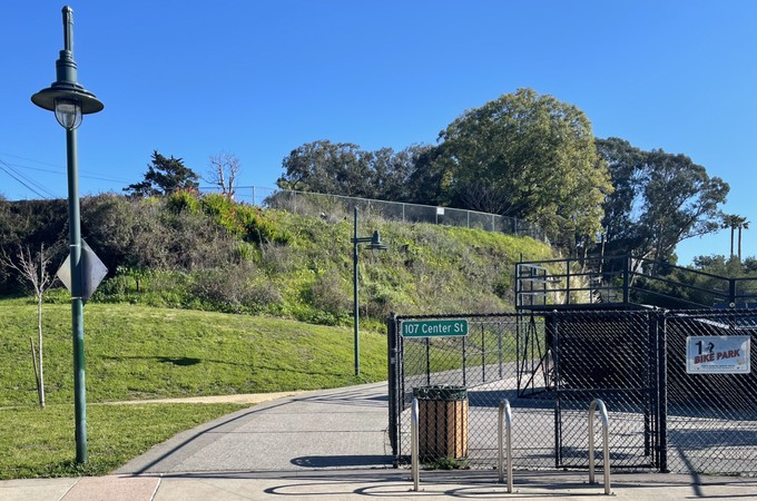 Looking west toward the path going to the left of the bicycle pump track.