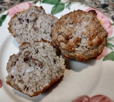 Two muffins on a cream-colored plate