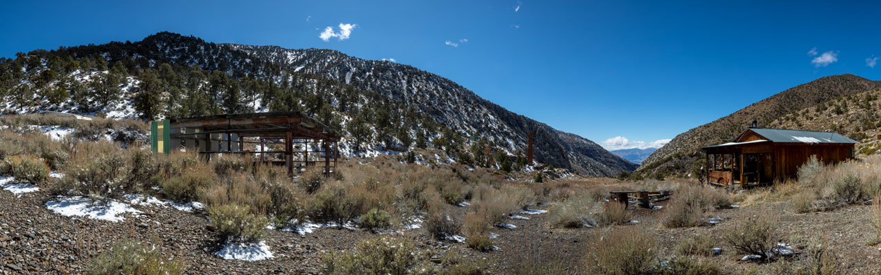 Landscape of buildings and snowy mountains around Panamint City ghost town