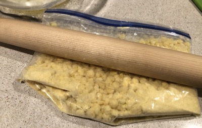 Crushed cereal in a plastic and rolling pin sitting on top