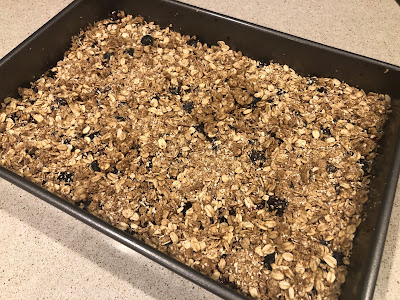 Oat mixture on top of fruit in pan