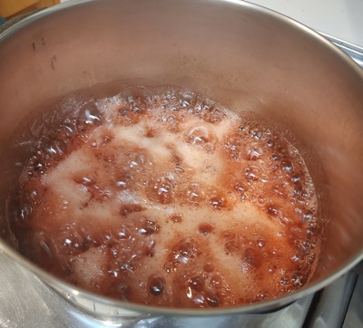 Strawberries boiling in a pot