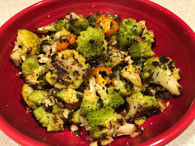 Cooked green veggies in a red bowl