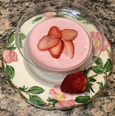 pink soft dessert in bowl with strawberry
