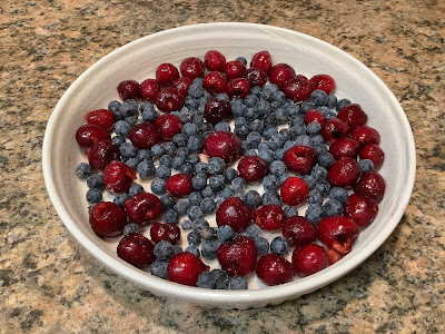 Cherries and blueberries in a white dish
