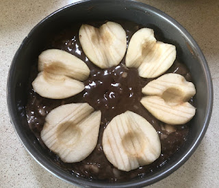 Cake pan with batter and pear halves