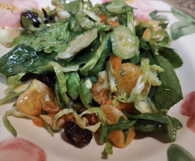 Closeup of green salad with orange fruit