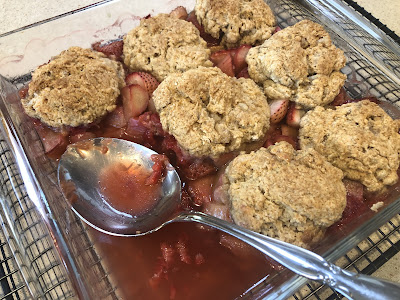 Baked cobbler with serving spoon