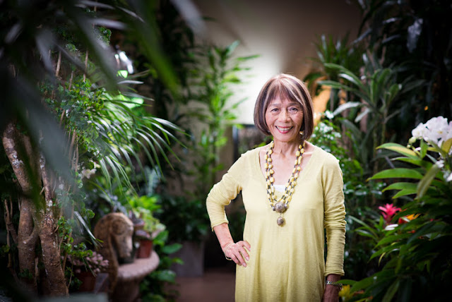 Woman standing amid many exotic plants