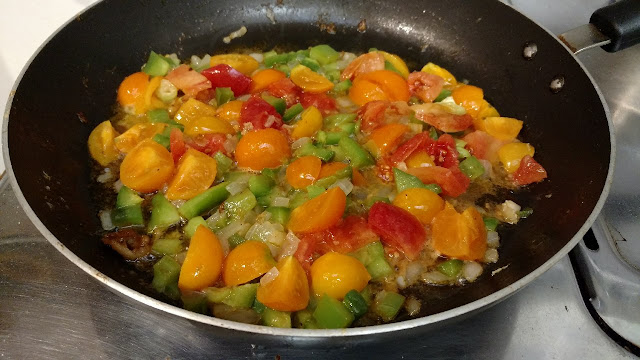 Mixture of tomatoes and peppers in pan